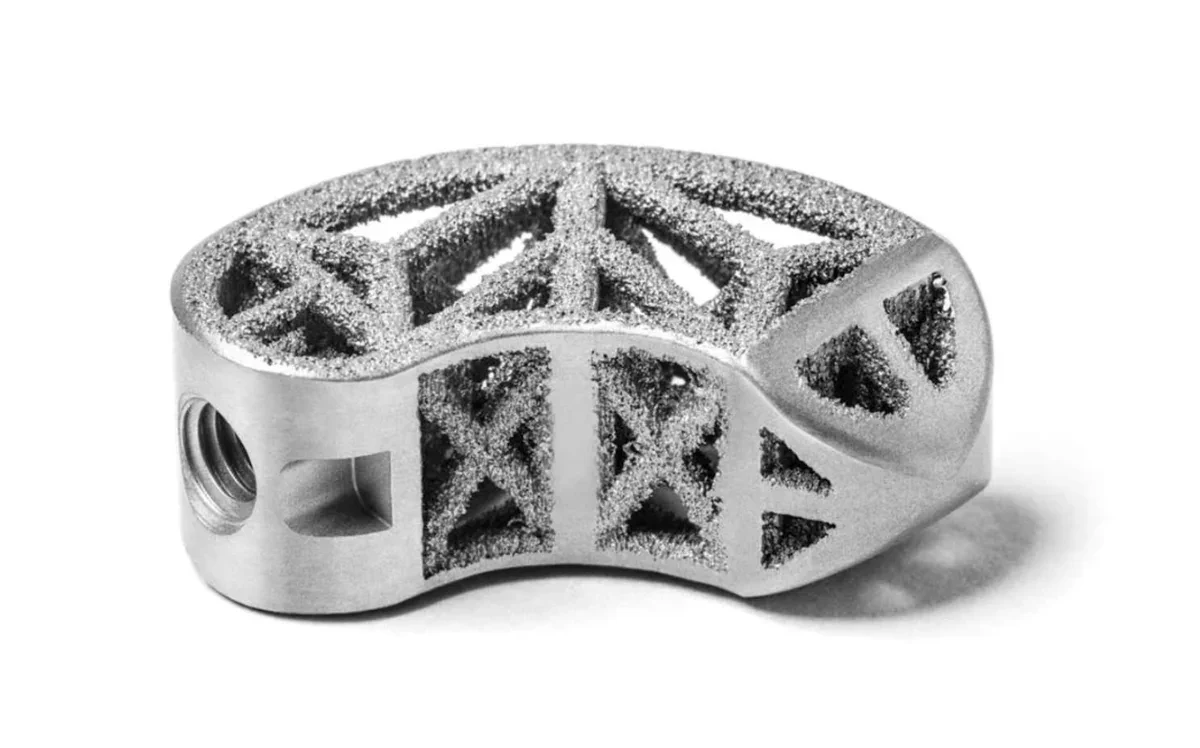 Metal component with lattice structure, showcasing DMLS or EBM 3D printing surface finish.